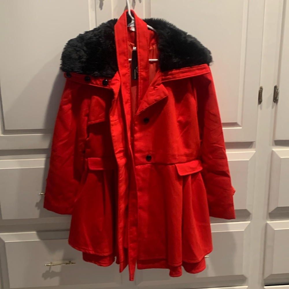 Very cute red coat.  Not my sister’s style and too big for me